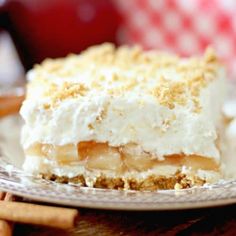 a piece of pie sitting on top of a plate next to cinnamon sticks and an apple