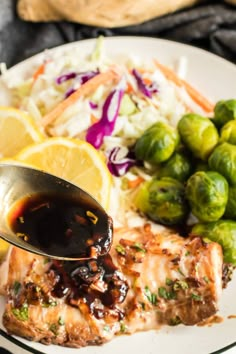 a white plate topped with chicken, brussel sprouts and brussels sprouts