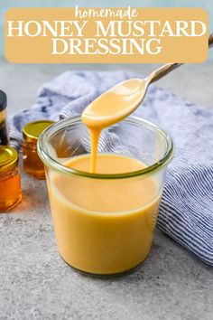 homemade honey mustard dressing in a glass bowl with a wooden spoon