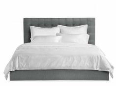 a bed with white sheets and pillows is shown in this black and white photo,