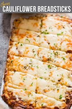 a cheesy cauliflower breadsticks is cut into squares and placed on a baking sheet