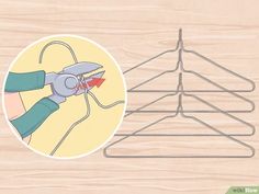 a clothes hanger with scissors on it next to an image of a wooden background