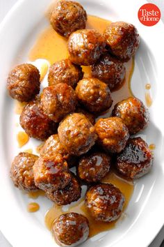 some meatballs are sitting on a plate with sauce