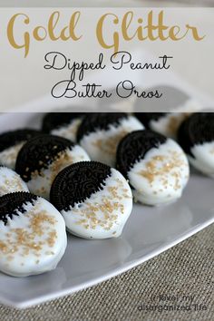 oreo cookies with white frosting and gold sprinkles on a plate