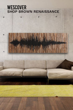 a white couch sitting in front of a wall with a sound wave painting on it