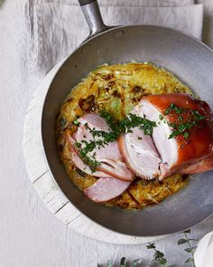 ham and potatoes in a pan with parsley garnish on the side, ready to be eaten