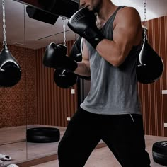 a man wearing boxing gloves in a gym