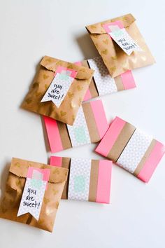 some brown and pink paper bags with tags on them