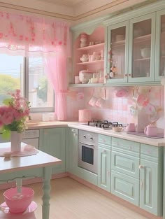 a pink and green kitchen with flowers in the vase on the stove top, window over the sink