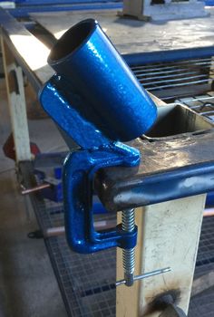 a blue cup sitting on top of a piece of metal