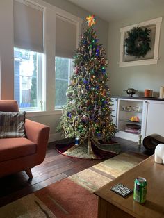 a living room with a christmas tree in the corner