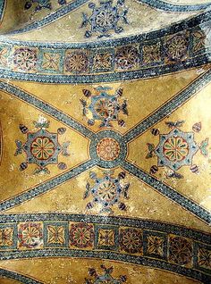 an elaborately decorated ceiling in the middle of a room with gold and blue paint