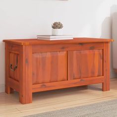 a wooden table with a potted plant sitting on it's top next to a couch