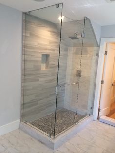 a walk in shower sitting inside of a bathroom