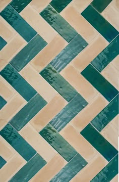 a tile floor with green and beige chevrons