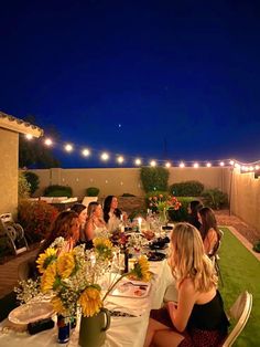 a group of people sitting at a dinner table