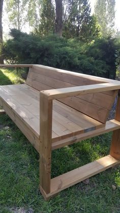 a wooden bench sitting on top of a lush green field