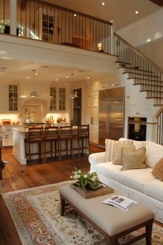 a living room filled with furniture and a stair case