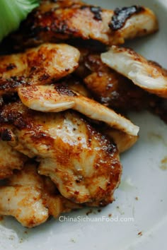 grilled chicken and lettuce on a white plate