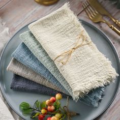 a plate topped with four different colored napkins