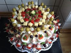 a cake with many different types of appetizers arranged on it's side