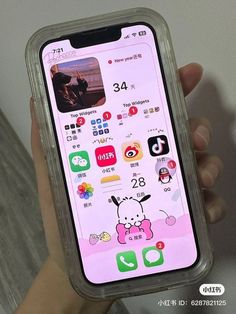 someone is holding up their phone with the app icons displayed on its display screen in front of them