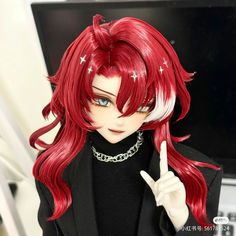 a doll with red hair is giving the peace sign