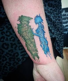 a person with a blue and green tattoo on their arm