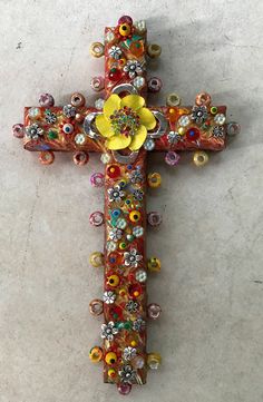 a cross made out of beads and flowers