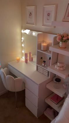 a bedroom with a vanity, mirror and lights on it's side table in front of a window