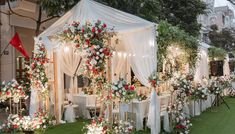 an outdoor wedding setup with white and red flowers