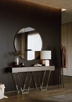 a modern console with a round mirror on the wall