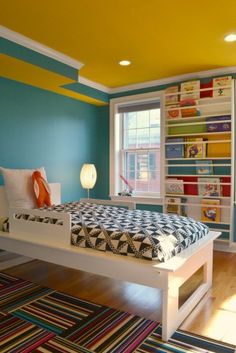 a bed room with a neatly made bed next to a book shelf filled with books