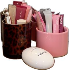 a pink and brown cup with various items in it