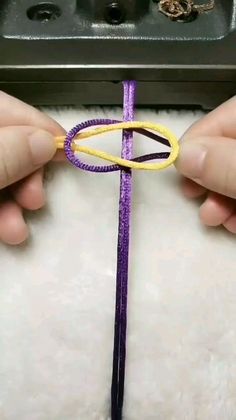 someone is making something with yarn and scissors