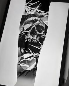 a black and white photo of a skull on paper