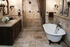 a bath room with a tub a sink and mirrors