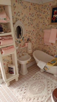 a doll house bathroom with toilet, sink and bathtub