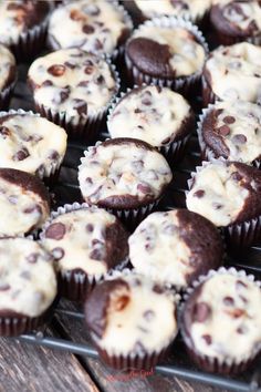 chocolate chip muffins with white frosting on a cooling rack, ready to be eaten