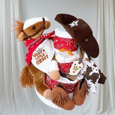 a teddy bear sitting on top of a chair with cowboy hats and other stuffed animals