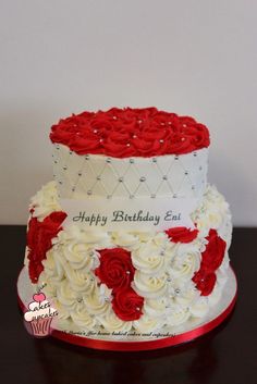 a white and red birthday cake with roses on it