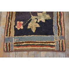 an old rug on the floor with wood floors