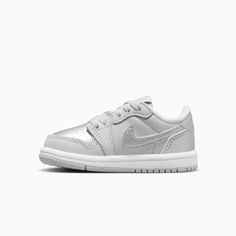 Jordan 1 Retro Low "Silver"Baby/Toddler ShoesEvery Jordan Retro is a classic sneaker done up in new colors and textures for a fresh look. With metallic silver leather, this iteration gives little feet stand-out style. Plus, premium materials and accents keep the look modern and on point. Real and synthetic leather in the upper helps add durability and structure.Foam sockliner helps cushion little feet.Rubber in the outsole helps give kiddos the traction they need. More Details Classic laces The Shoes Grey, Kids Jordans, Air Jordan 1 Retro, Classic Sneakers, Jordan 1 Retro, Jordan Retro, Toddler Shoes, Air Jordan 1, White Style