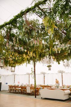 an outdoor tent with tables and couches under the canopy is featured on instagram