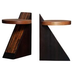 two pieces of wood sitting side by side on top of each other in the shape of a triangle