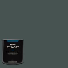 a can of paint sitting on top of a white floor next to a gray wall