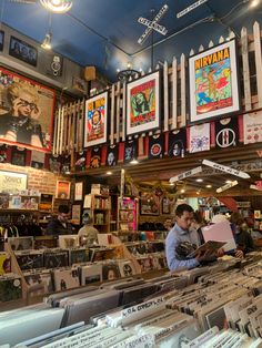 a man sitting at a counter in a record store