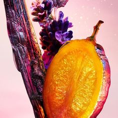 an orange and some purple flowers on a pink background