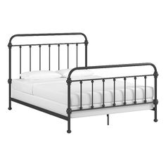 a black metal bed frame with white sheets