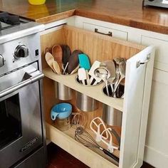 a kitchen with an oven, dishwasher and various utensils in it